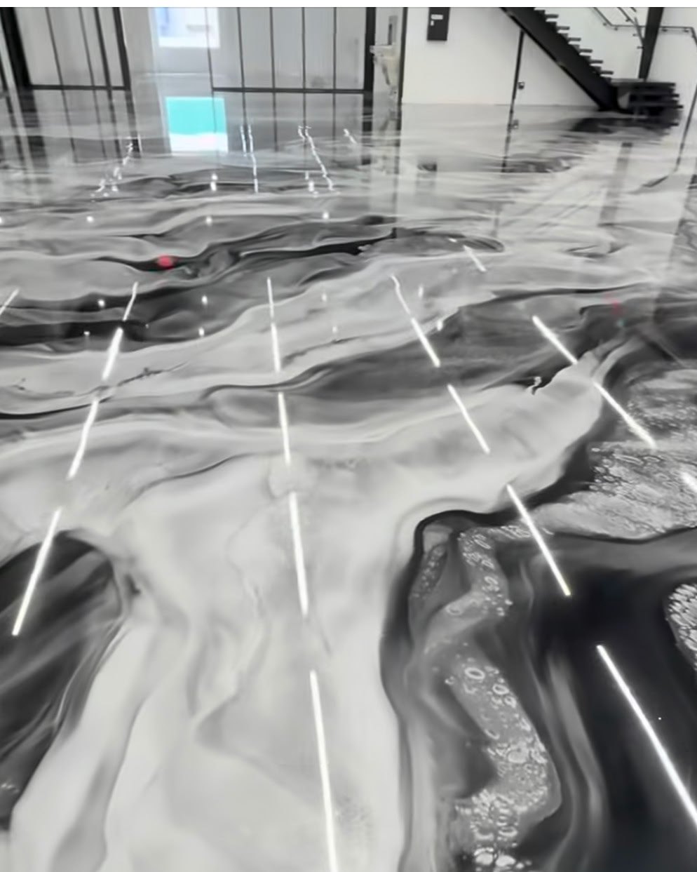 A black and white metallic epoxy pour by Atlas Epoxy Floors