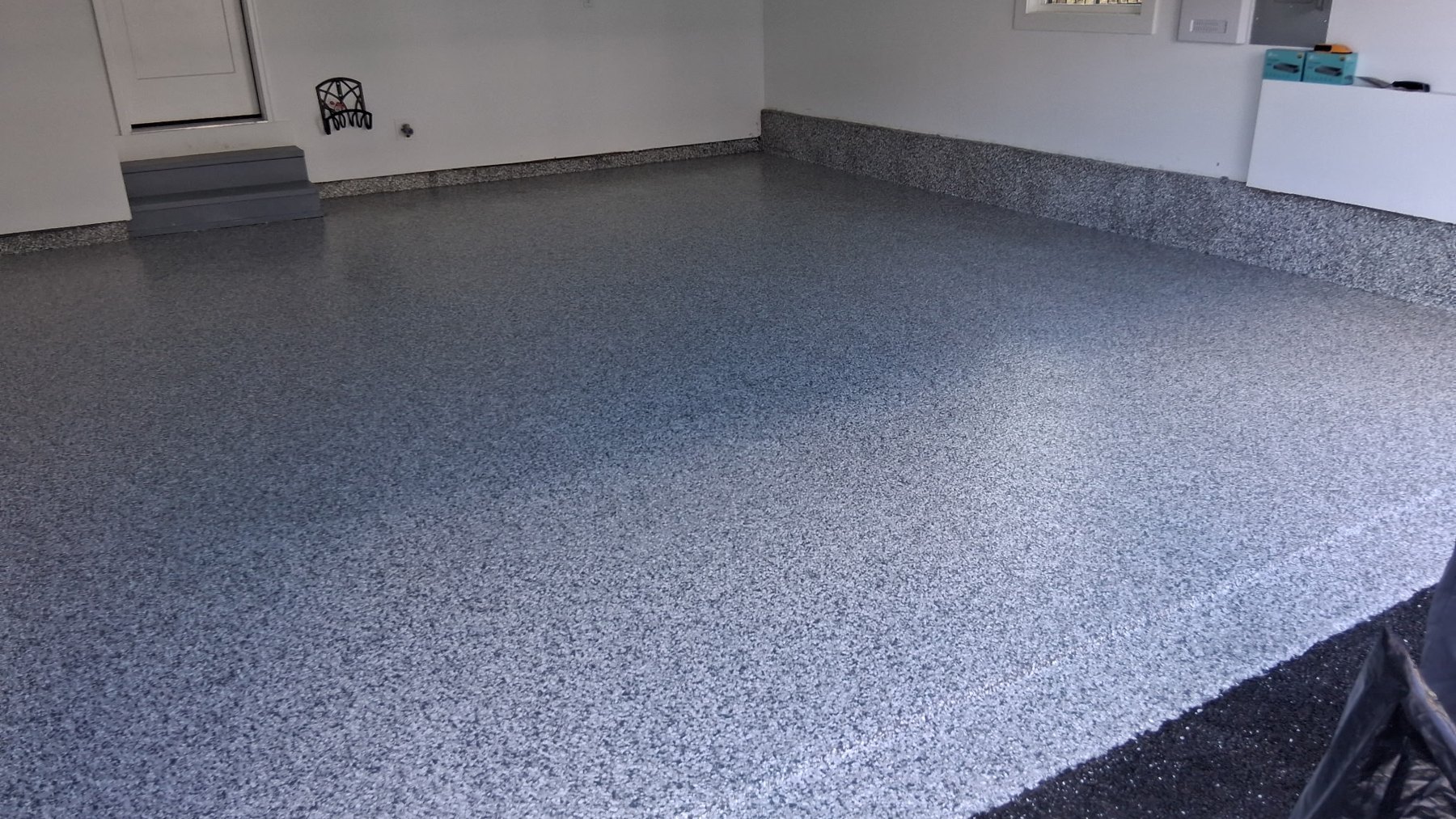 A finished flake garage floor installed by Atlas Epoxy Floors