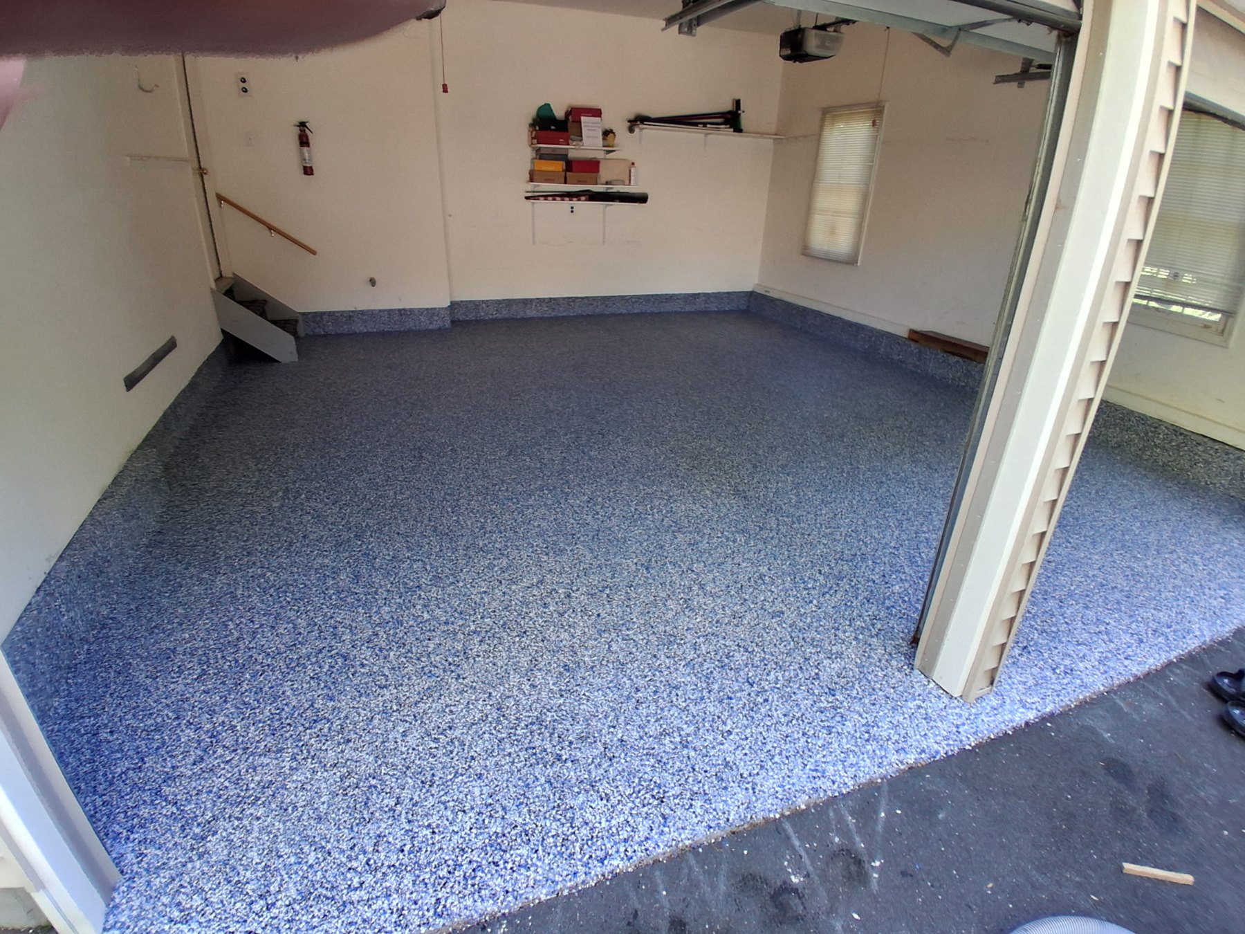 Blue flake garage floor with a coved edge